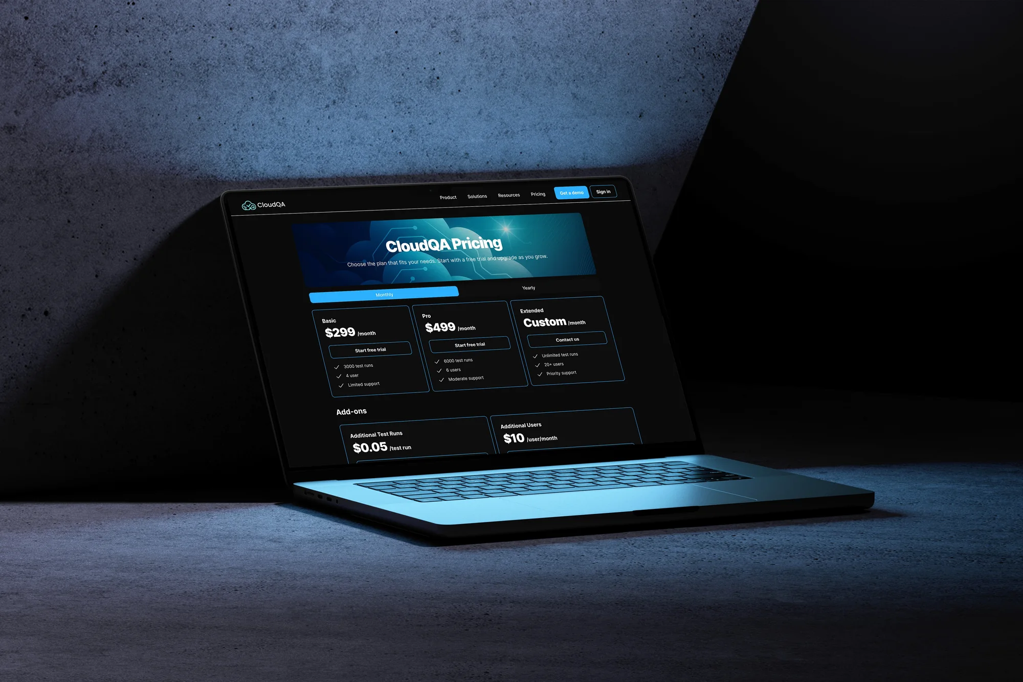 The page in context. Most of these decisions get made on a work machine, mid-afternoon, with three other tabs open. The CloudQA pricing page shown on a laptop in a dark studio setting